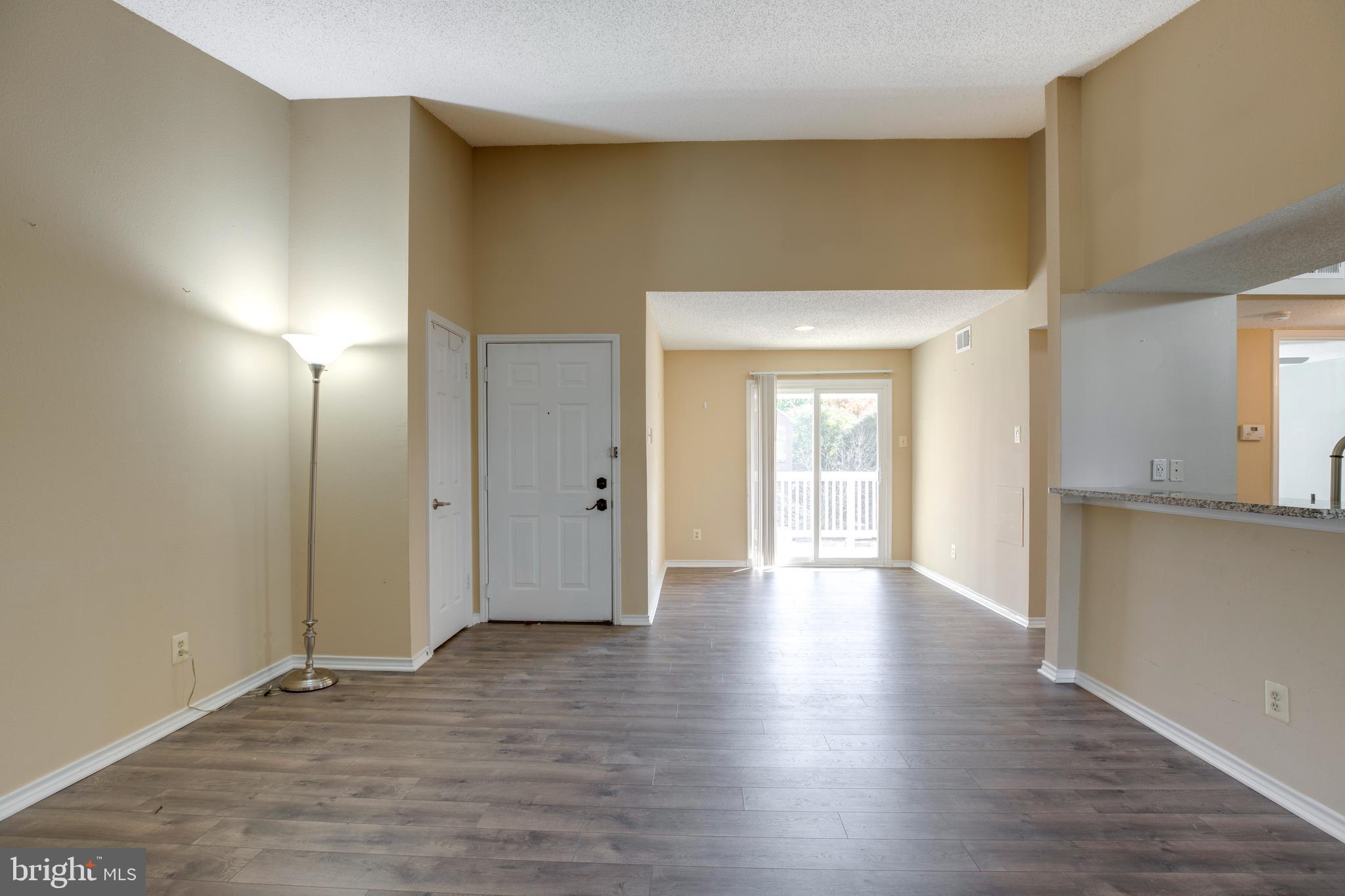 1543 Lincoln Way, Unit 301B McLean, VA 22102 - Photo 7 of 30 a view of an empty room with wooden floor and a window