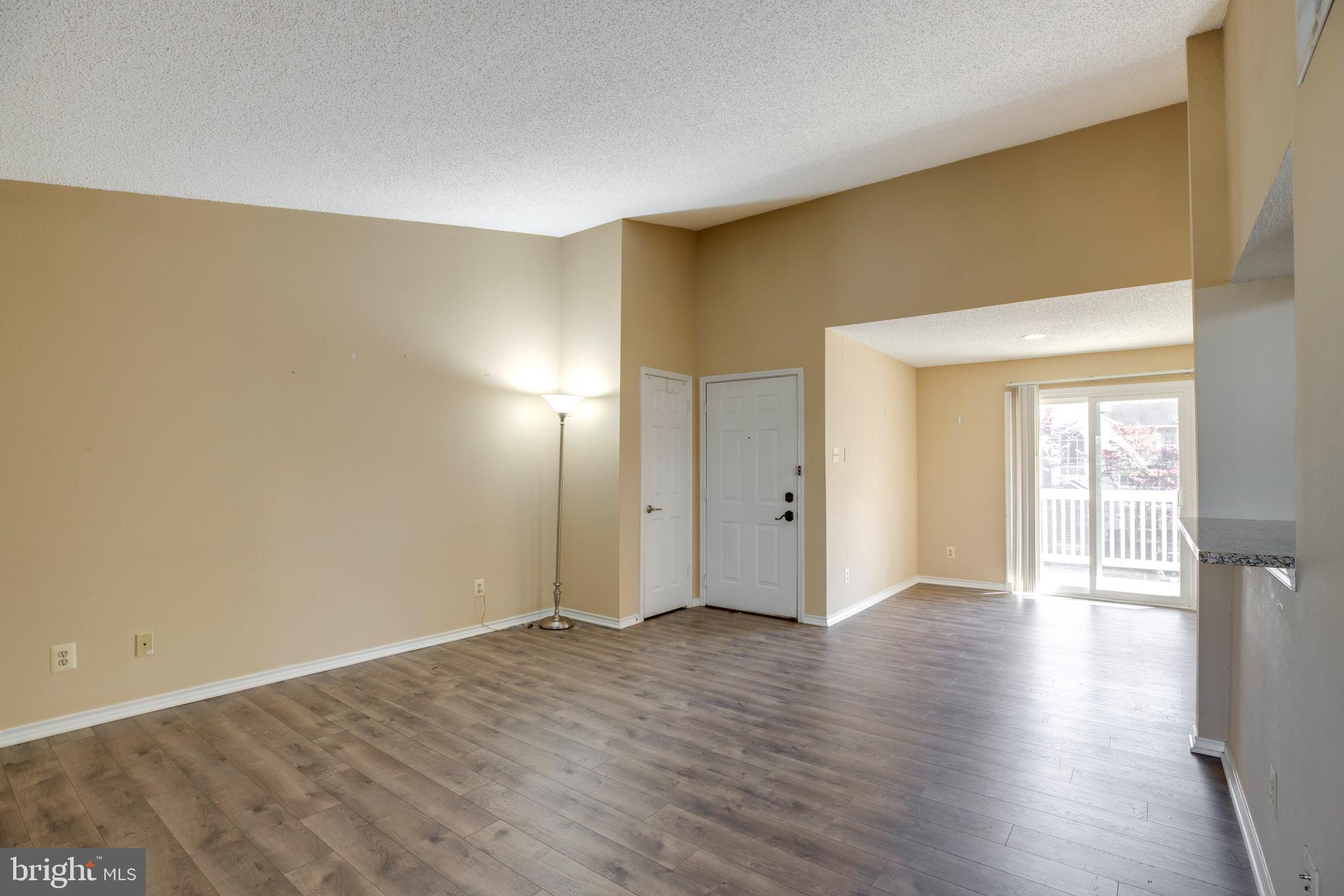 1543 Lincoln Way, Unit 301B McLean, VA 22102 - Photo 8 of 30 a view of an empty room with wooden floor and a window