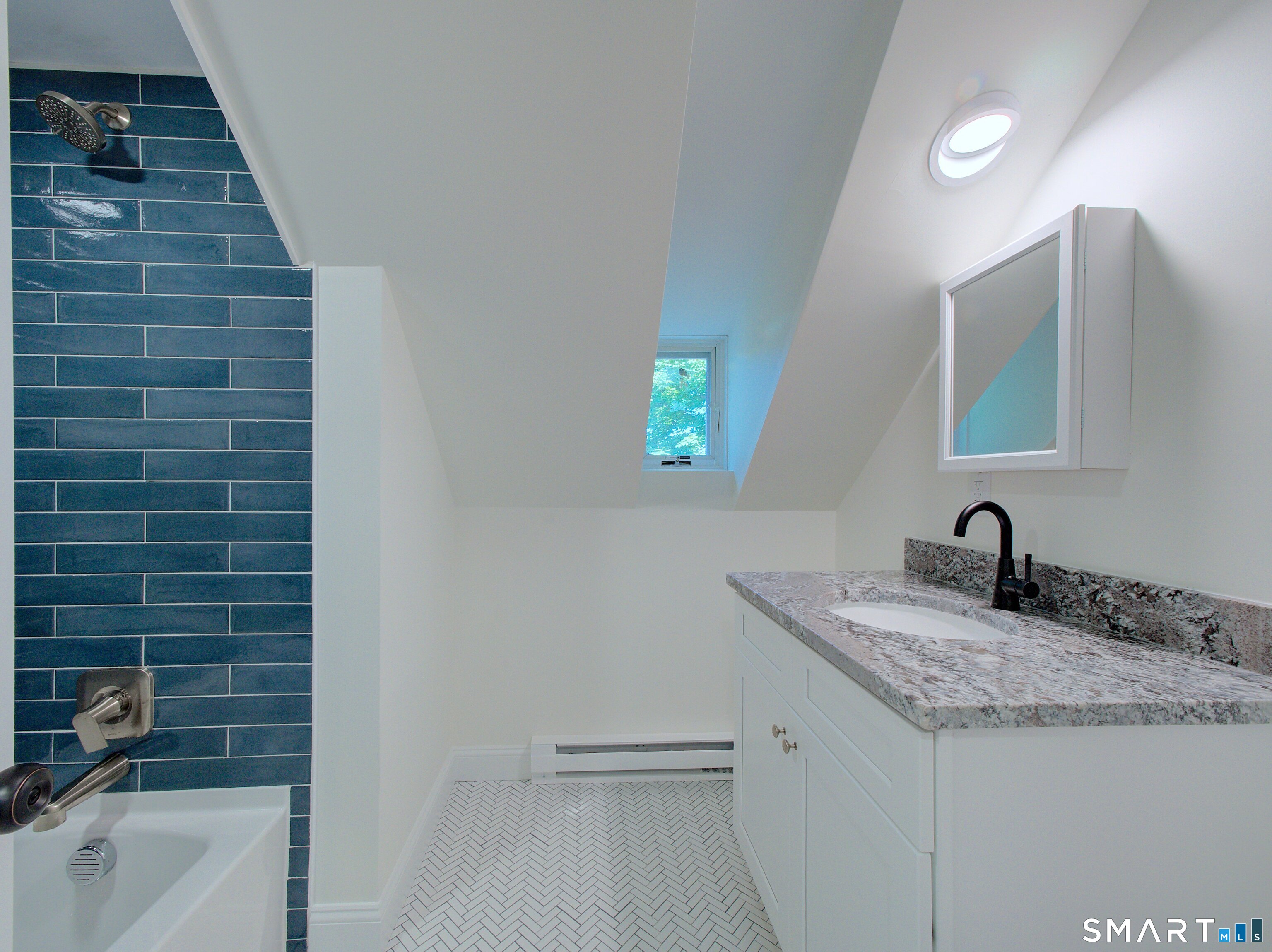16 Benham Road, Unit D Groton, CT 06340 - Photo 5 of 15 a bathroom with a granite countertop sink a toilet and bathtub