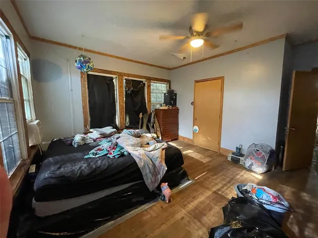 a bedroom with bed and a chandelier