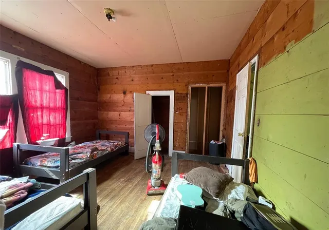 a bedroom with furniture and a window