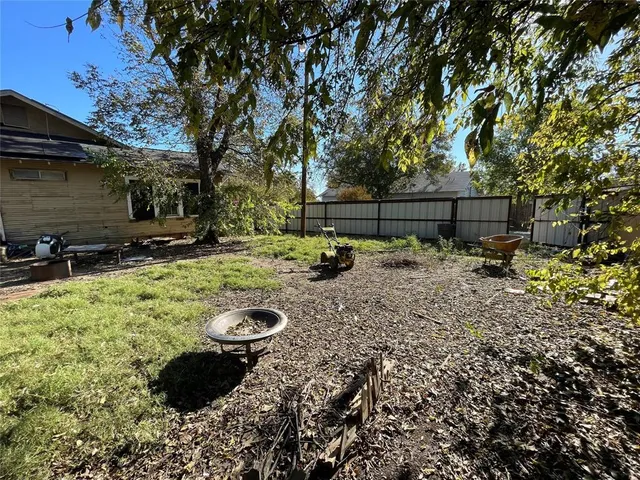 a backyard of a house with barbeque oven