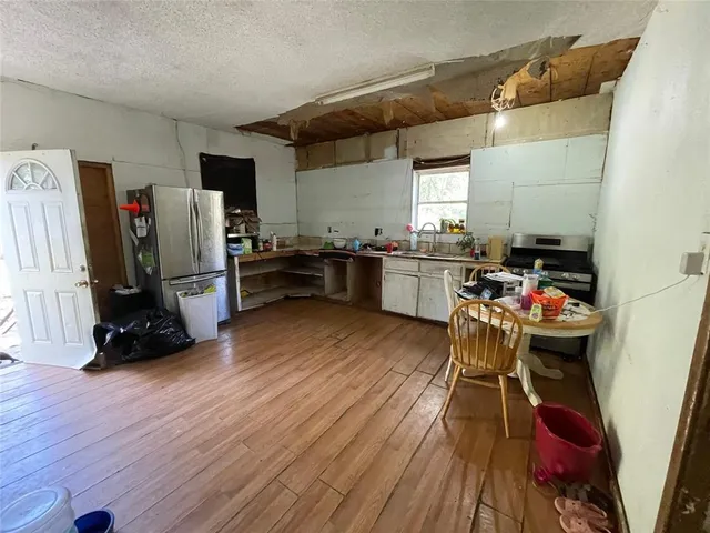 a kitchen that has a lot of cabinets a sink and a stove