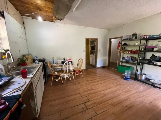 a dining room with furniture and wooden floor