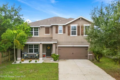 a front view of a house with a yard and porch