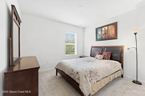 a bedroom with a bed and a book shelf