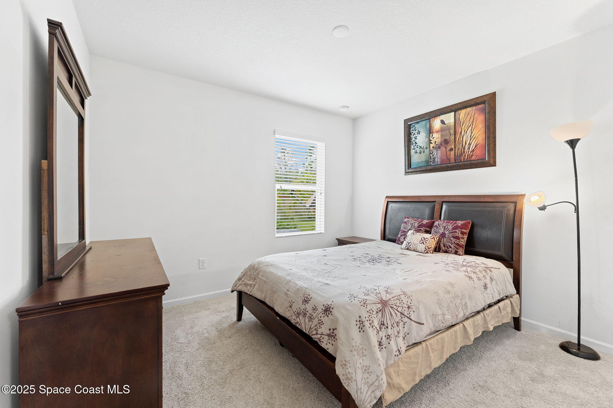 262 Alamere Drive Southwest Palm Bay, FL 32908 - Photo 11 of 34 a bedroom with a bed and a night stand