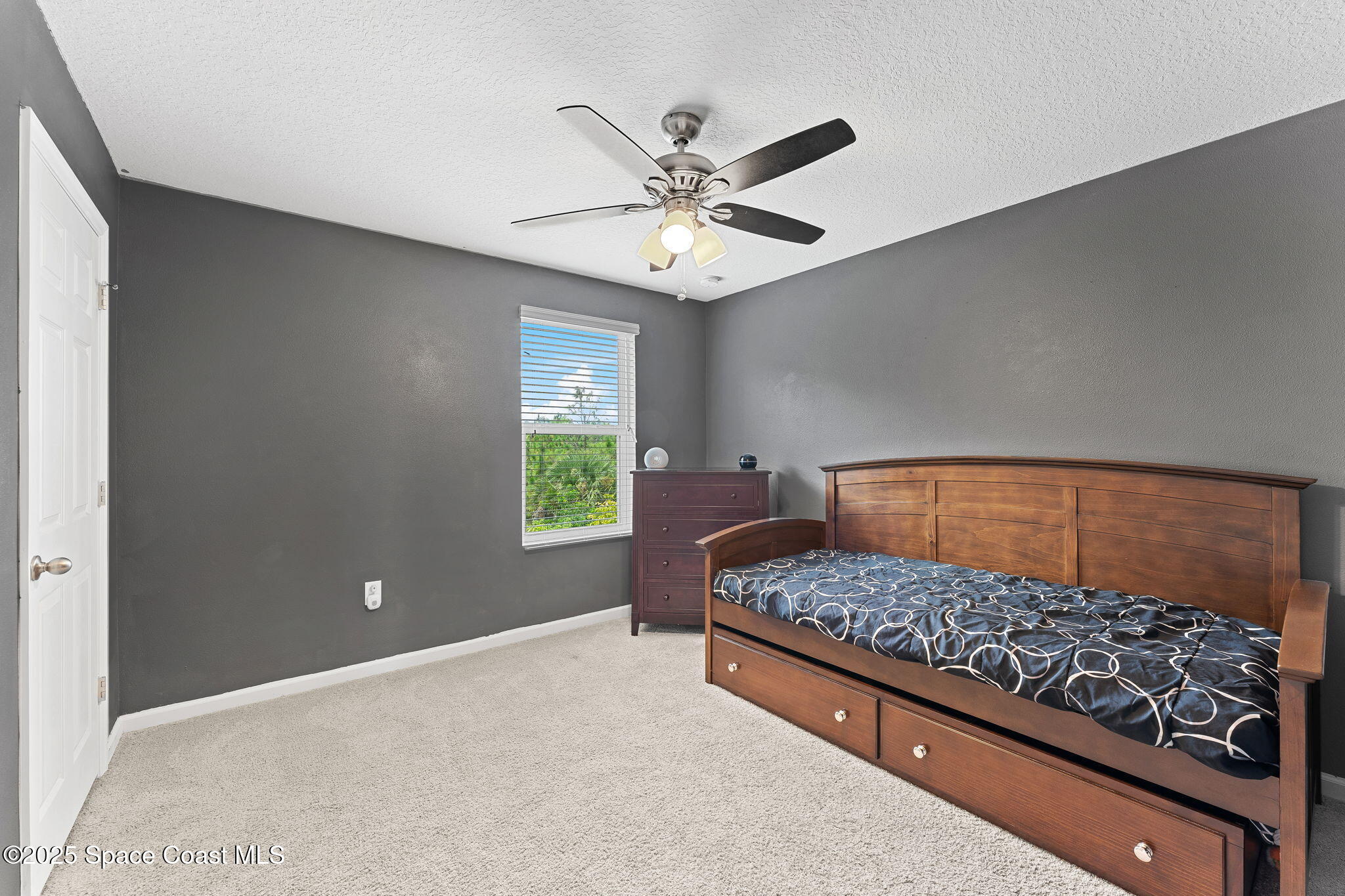 262 Alamere Drive Southwest Palm Bay, FL 32908 - Photo 17 of 34 a bedroom with a bed and a chandelier