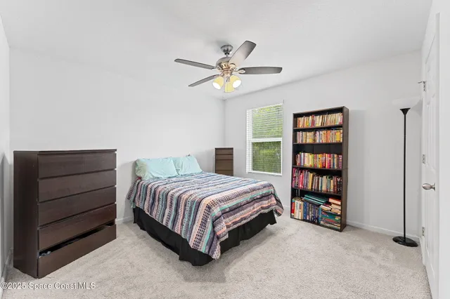 a bedroom with a bed and a book shelf