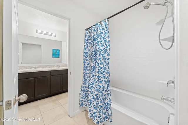 a bathroom with a bathtub sink and a mirror