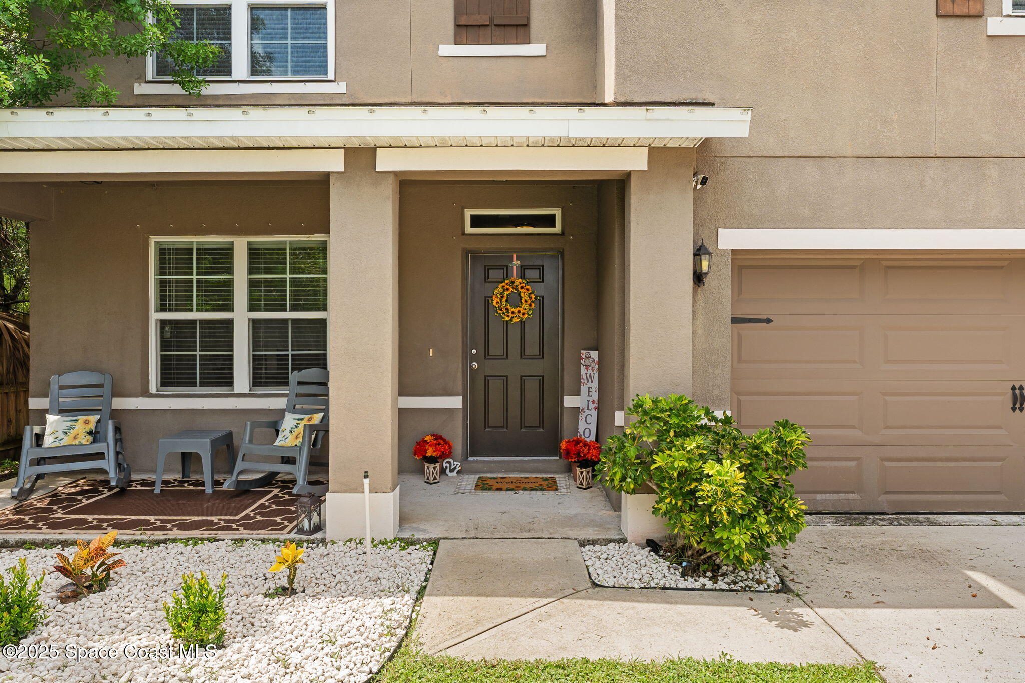 262 Alamere Drive Southwest Palm Bay, FL 32908 - Photo 2 of 34 a front view of a house with a garden