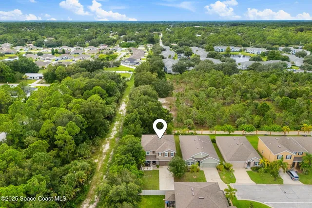 an aerial view of a house with a garden
