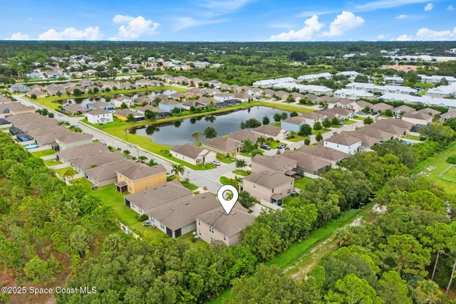 an aerial view of residential houses with outdoor space and swimming pool