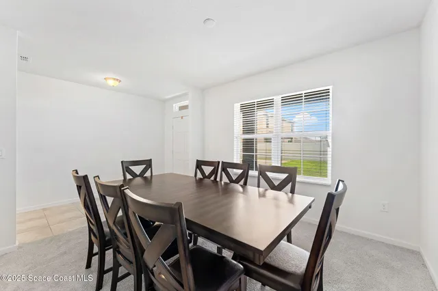 a view of a dining room with furniture and window