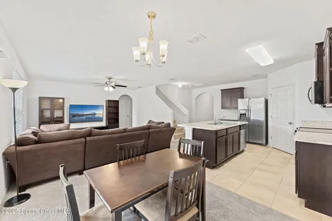 a kitchen with stainless steel appliances kitchen island granite countertop a refrigerator a stove and a sink with granite countertops