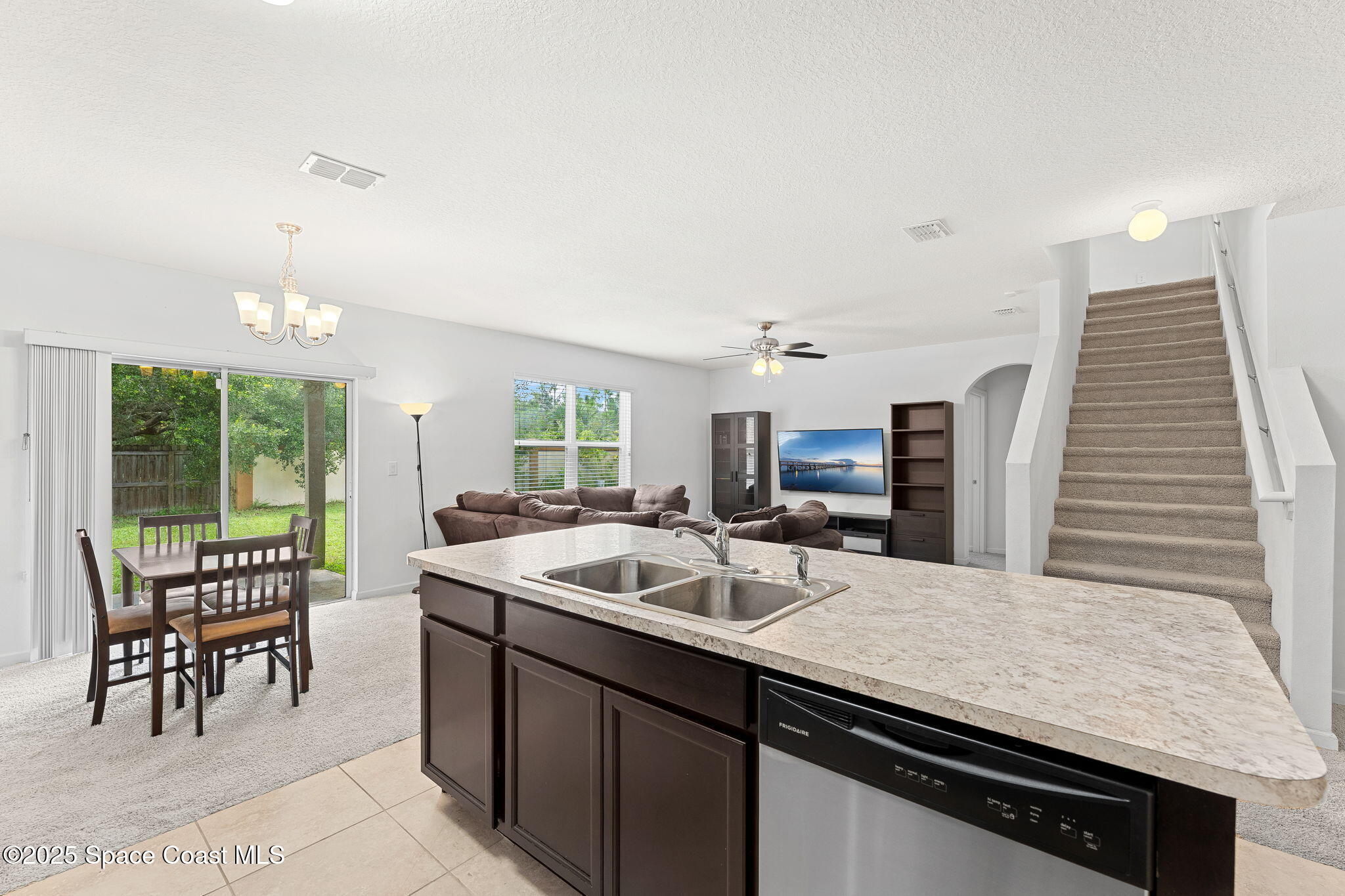 262 Alamere Drive Southwest Palm Bay, FL 32908 - Photo 7 of 34 a kitchen with a sink and chairs