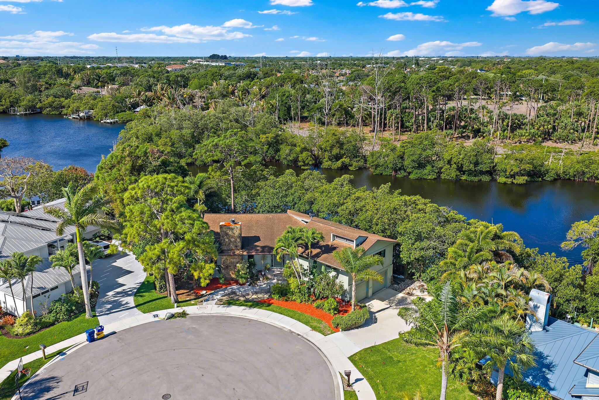 702 Warren Drive Jupiter, FL 33458 - Photo 60 of 76 an aerial view of a house with a garden and lake view