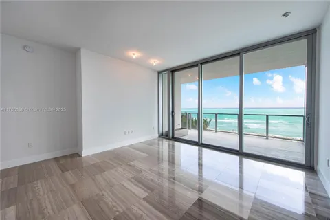a view of an empty room and wooden floor