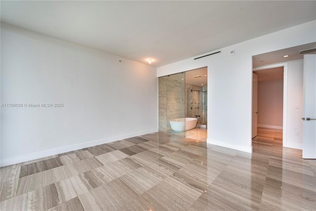 a bathroom with a double vanity sink a large mirror and shower