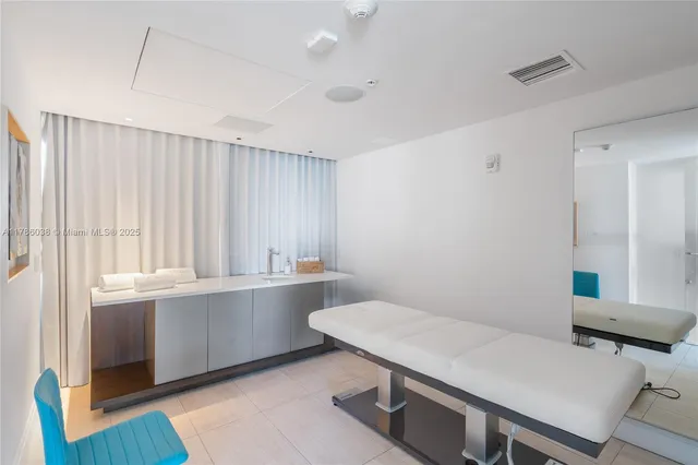 a living room with couches and a dining table with wooden floor