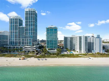 a view of a dining room that has a table and chairs in it
