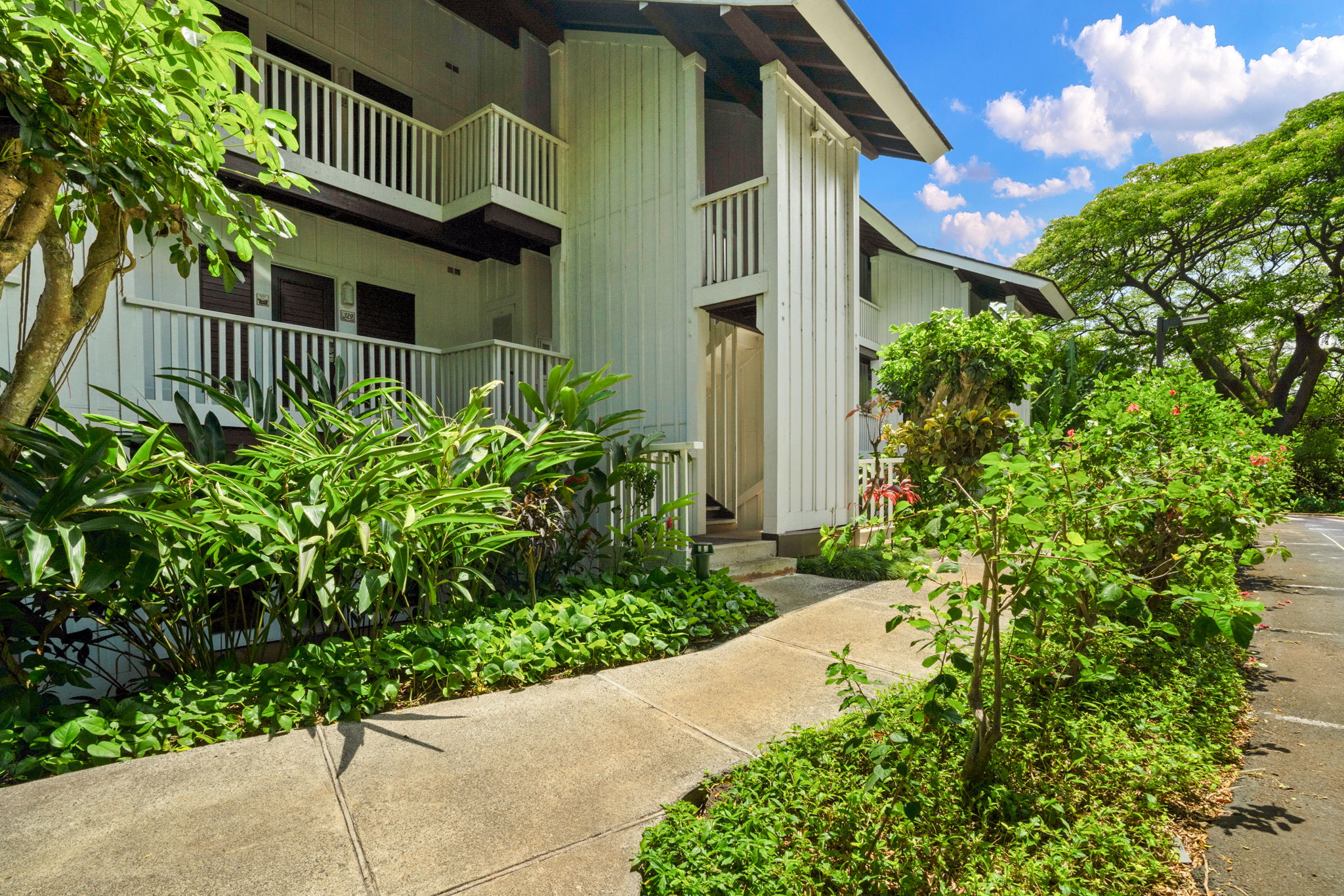 2253 Poipu Road, Unit 330 Koloa, HI 96756 - Photo 21 of 26 a front view of a house with a yard
