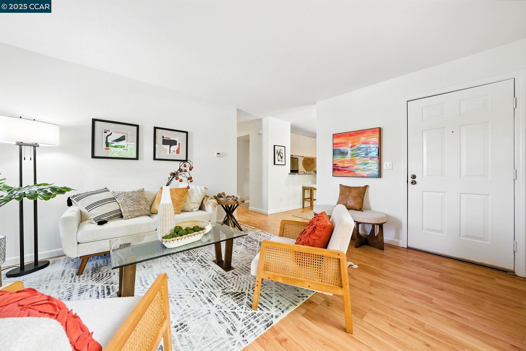 a living room with furniture and wooden floor