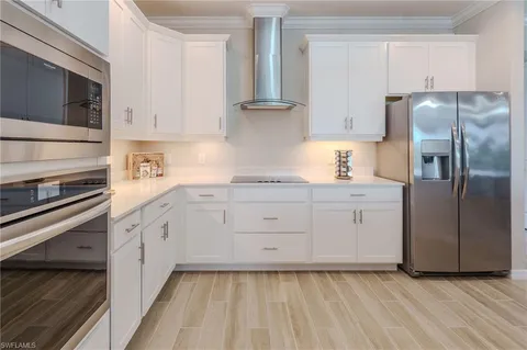 a kitchen with stainless steel appliances a stove microwave and cabinets
