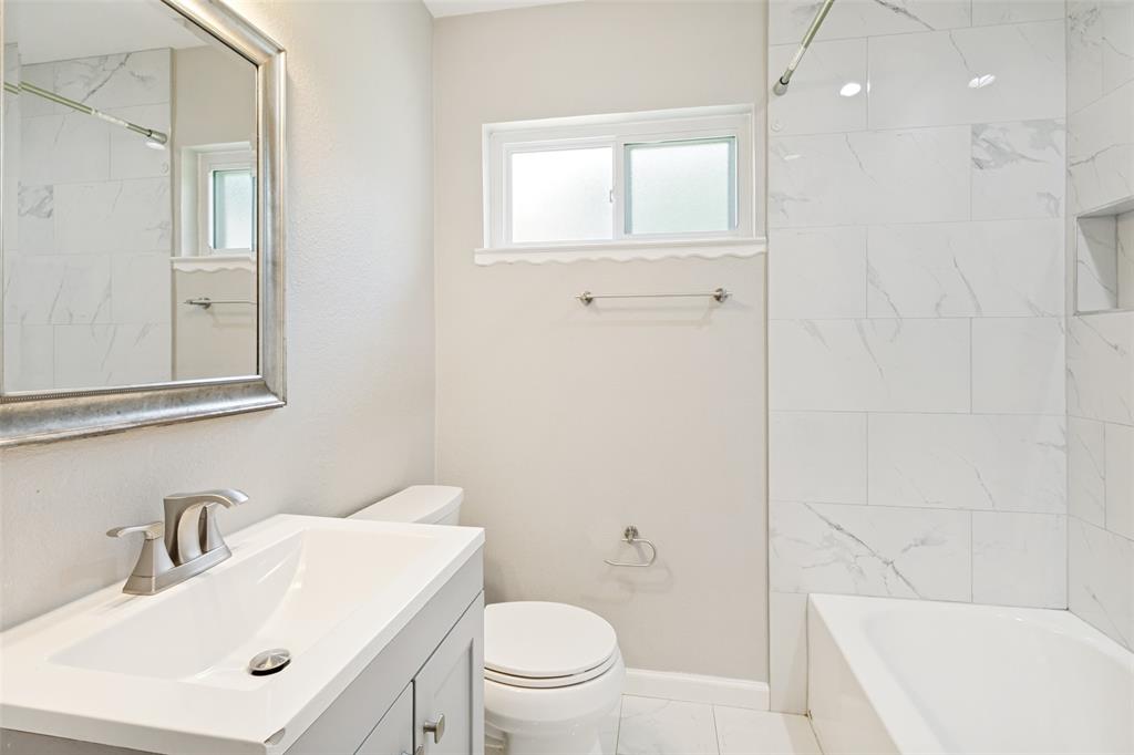 11524 Strand Street Dallas, TX 75218 - Photo 15 of 19 a bathroom with a sink toilet vanity and bathtub