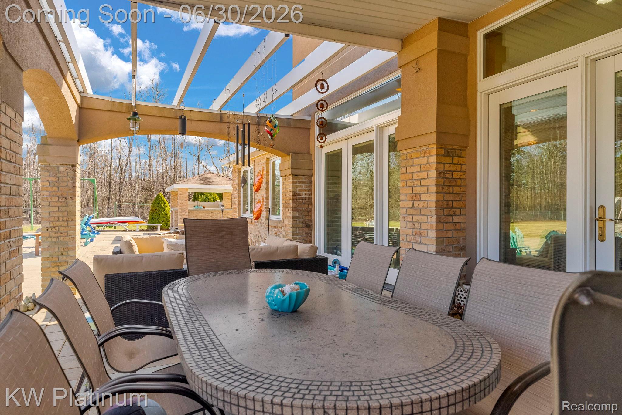 2235 South Lake Shore Road Harbor Beach, MI 48441 - Photo 54 of 99 Covered patio featuring an open pergola roof structure, brick columns, archways, and direct access through glass panel doors