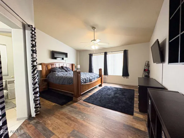 a bedroom with a bed and flat screen tv