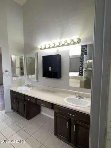 a bathroom with a double vanity sink and a mirror
