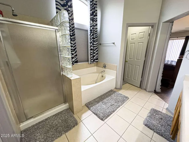 a bathroom with a tub shower and sink