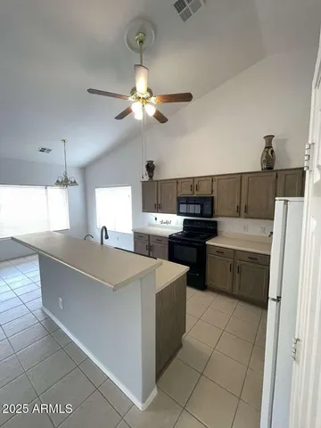 a kitchen with a stove a sink and a refrigerator