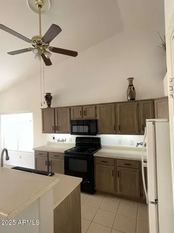 a kitchen with a cabinets and white appliances