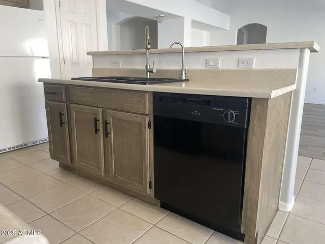 a kitchen with a sink and cabinets