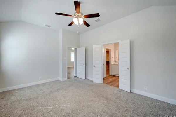 wooden floor in an empty room and a ceiling fan