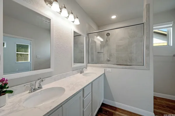 a bathroom with a double vanity sink and mirror