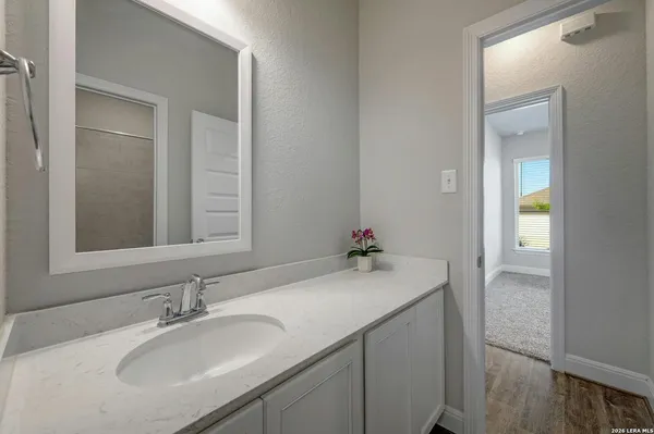 a bathroom with a sink vanity and a mirror