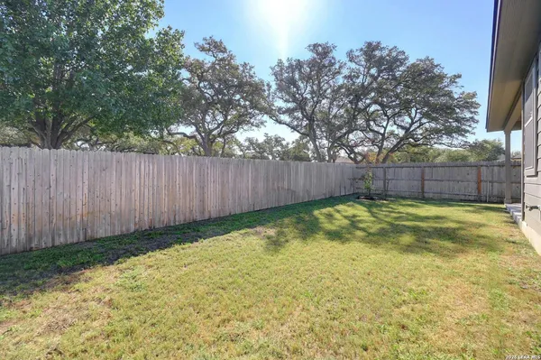 a view of swimming pool with wooden fence