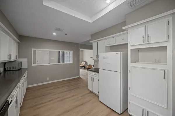 a white refrigerator freezer sitting inside of a kitchen