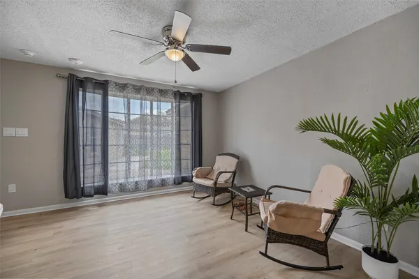 a living room with furniture and floor to ceiling window