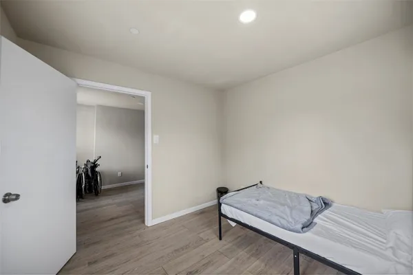 a bedroom with a bed and wooden floor