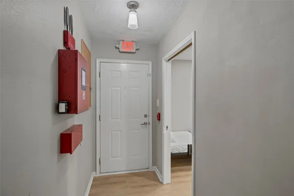a view of a hallway with wooden floor and closet