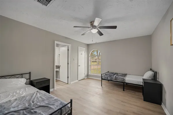 a bedroom with furniture and a window