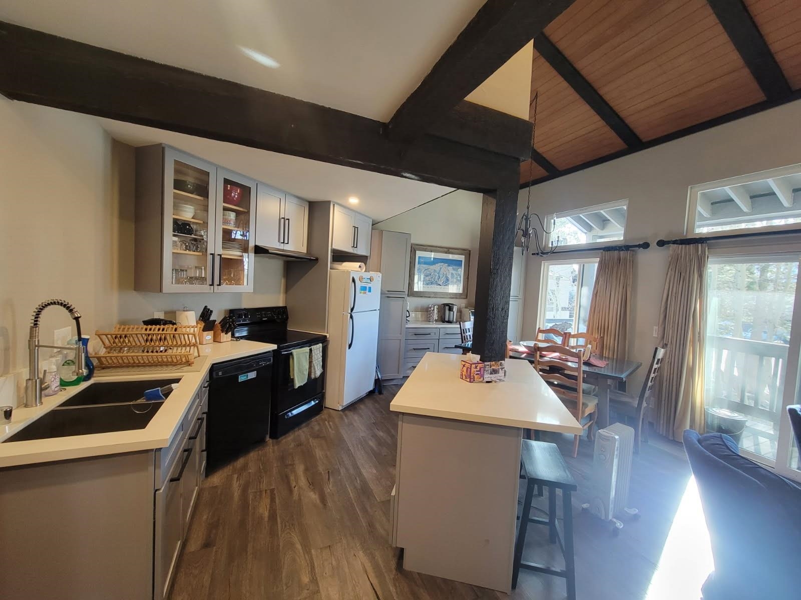 362 Old Mammoth Road, Unit 36 36 Mammoth Lakes, CA 93546 - Photo 1 of 1 a kitchen with a table chairs stove and wooden floor