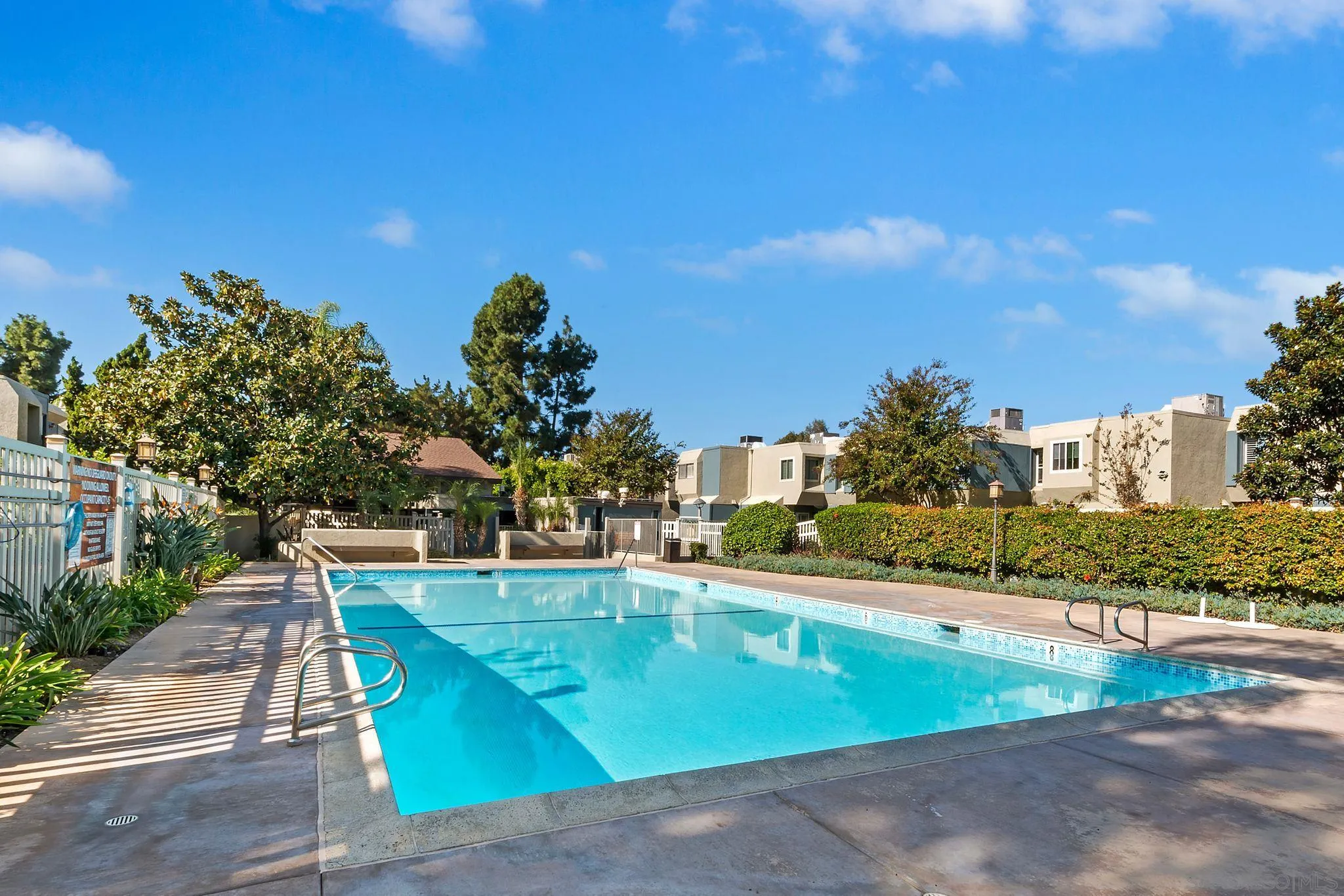 6395 Rancho Mission Road, Unit 8 San Diego, CA 92108 - Photo 31 of 32 a view of a swimming pool with an outdoor space and seating area