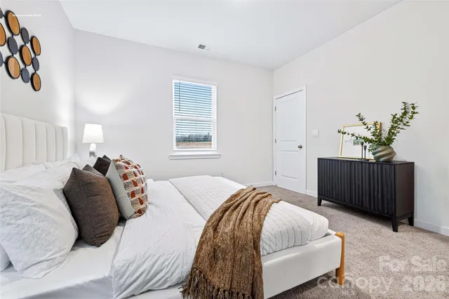 a bed room with a bed and a window