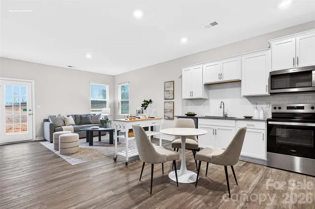a view of kitchen with cabinets table and chairs
