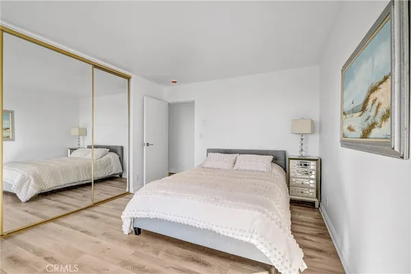 a bedroom with a large bed and a dresser